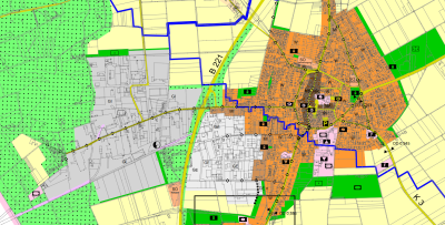 Kartenauszug Bracht mit verschieden großen, farbigen Flächen zur Ausweisung bestimmter Nutzungen, zum Beispiel grün für Wald- und Grünflächen, große orangefarbige Fläche rechts, blaue Linie von oben links bis unten rechts, geleb Linien für Straßen, zum Beispiel B221, schwarze kleine Rechtecke mit verschiedenen Symbolen, alle Beschriftungen in schwarz